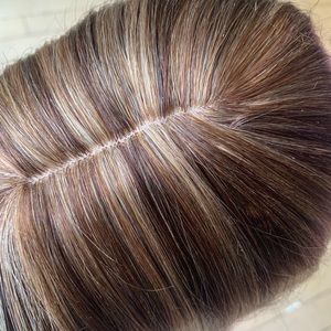 100% human hair topper. It does not have bangs.About 12” in length. Has 4 clips.